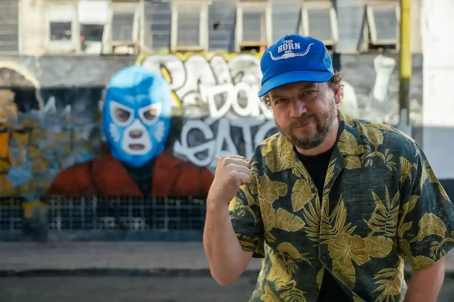 Danny McBride pointing to Don Gato mural